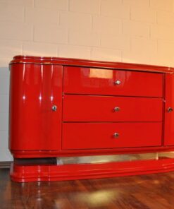 Art Deco Lowboard, red highgloss paintjob, wonderful swing doors, 3 drawers with chromehandles, chromeapplications on the foot
