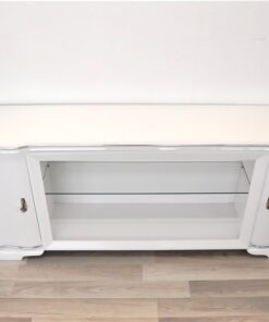 Art Deco Lowboard, lacquer in highgloss white, curved doors in a classic design, glass shelve in the middle compartement, chromelines