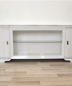 Art Deco Lowboard, lacquer in highgloss white, curved doors in a classic design, glass shelve in the middle compartement, chromelines