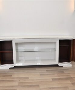 Art Deco Lowboard, lacquer in highgloss white, curved doors in a classic design, glass shelve in the middle compartement, chromelines