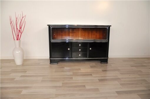 Art Deco Sideboard,black pianolacquer and chrome applications, 2 glas sliding doors infront of a big vitrine compartement, 3 drawers and 2 doors