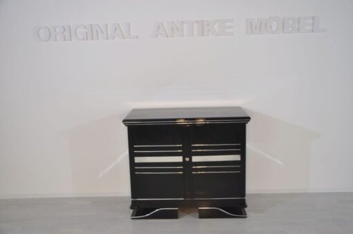 Art Deco Commode, straight forward body language, big chrome applications, wonderful foot, pianolacquer in highglossblack, interior made of cherrywood