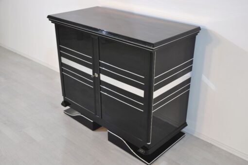 Art Deco Commode, straight forward body language, big chrome applications, wonderful foot, pianolacquer in highglossblack, interior made of cherrywood